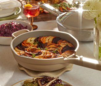 beige always pan with cooked food set on table