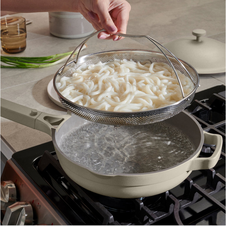 beige always pan stovetop with noodles