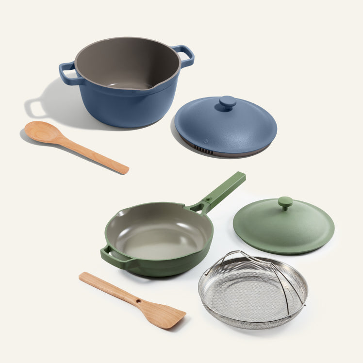 A blue Perfect Pot with spoon and a green Always Pan with spoon and steamer basket