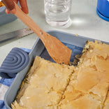 blue griddle pan with spatula and flaky pastry