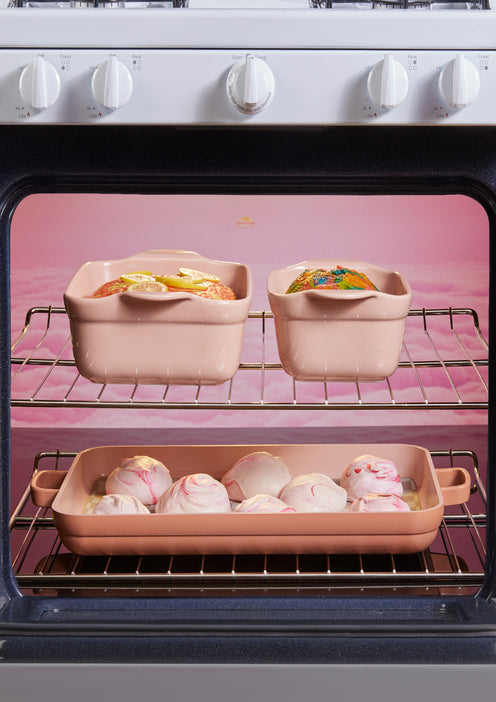 pink bakeware set in oven with sweets