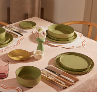 sage tableware set on table - includes dinner bowls, salad plates, soup bowls, dessert plates and dinner plates